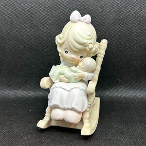 Precious Moments “Love Never Leaves a Mother's Arms" figurine